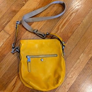 B. Makowsky mustard yellow leather and tan cloth strap crossbody
